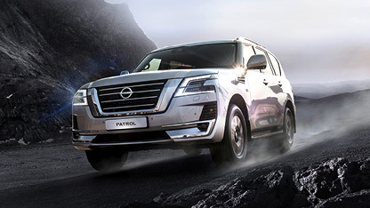 Nissan Patrol driving on wet mountain thumb