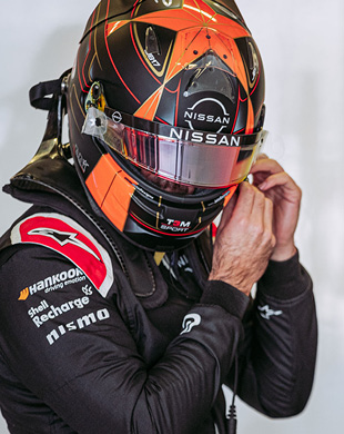 Formula E Driver adjusting his helmet